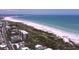 Panoramic aerial view of the beautiful beach adjacent to the condo, offering a serene coastal lifestyle at 1300 N Portofino Dr # 208, Sarasota, FL 34242