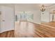 Bright living room with hardwood floors, ceiling fan, slider doors, and mirror wall at 1300 N Portofino Dr # 208, Sarasota, FL 34242