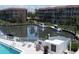 Condo community pool and spa area with lounge chairs overlooking canal and boat dock at 1300 N Portofino Dr # 208, Sarasota, FL 34242