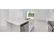 Kitchen island with stainless steel appliances and backyard views at 3051 Novara Ln, Lakewood Ranch, FL 34211