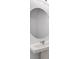 Modern bathroom features a white sink with a large, round mirror at 3055 Novara Ln, Lakewood Ranch, FL 34211