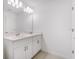 Bathroom boasts a dual sink vanity with white cabinets and a large mirror at 3055 Novara Ln, Lakewood Ranch, FL 34211