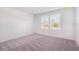A bedroom with carpet features natural light from windows, creating a relaxing atmosphere at 3055 Novara Ln, Lakewood Ranch, FL 34211