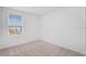 Bright bedroom features plush neutral carpet and a window with blinds at 3055 Novara Ln, Lakewood Ranch, FL 34211