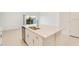 Modern kitchen island features a sink, dishwasher, and bar seating for casual dining at 3055 Novara Ln, Lakewood Ranch, FL 34211