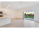 Bright living room connected to the kitchen, with a sliding glass door to the backyard at 3055 Novara Ln, Lakewood Ranch, FL 34211