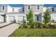 Two-story townhome with gray siding, two-car garage, and landscaped front yard at 3149 Novara Ln, Lakewood Ranch, FL 34211