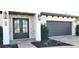 Beautiful home with modern gray garage door and landscaping at 500 Buttonwood Dr, Longboat Key, FL 34228