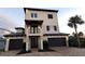 Three-story home with decorative stone and a three-car garage at 500 Buttonwood Dr, Longboat Key, FL 34228