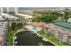 Aerial view of community, showing pool, tennis courts, and canal at 1300 N Portofino Dr # 208, Sarasota, FL 34242
