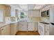 Efficient kitchen offering stainless steel appliances and wood flooring at 1300 N Portofino Dr # 208, Sarasota, FL 34242