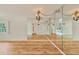 Bright dining room with hardwood floors and mirrored walls at 1300 N Portofino Dr # 208, Sarasota, FL 34242