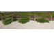 Beachfront dune landscape with yellow flowers at 1300 N Portofino Dr # 208, Sarasota, FL 34242