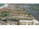 Aerial view of condo community near the water with tennis courts at 1300 N Portofino Dr # 208, Sarasota, FL 34242
