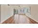 Living room with hardwood floors and access to a balcony at 1300 N Portofino Dr # 208, Sarasota, FL 34242