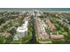 Wide aerial showcasing the community, tennis courts, and waterfront at 1300 N Portofino Dr # 208, Sarasota, FL 34242