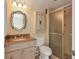 Clean bathroom with granite vanity and a shower at 1300 N Portofino Dr # 208, Sarasota, FL 34242
