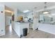 Modern kitchen with white cabinets, gray countertops, and a breakfast bar at 4802 51St W St # 1305, Bradenton, FL 34210