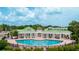 Community pool with lounge chairs and pergola at 4802 51St W St # 1305, Bradenton, FL 34210