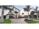 Stunning three-story home with two-car garage and tropical landscaping at 500 Buttonwood Dr, Longboat Key, FL 34228