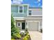 Two-story townhome with teal and beige siding and a two-car garage at 3051 Novara Ln, Lakewood Ranch, FL 34211