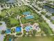 Picturesque aerial view of a community park featuring tennis courts, playground, and a splash pad for residents at 11406 Belvedere Ter, Lakewood Ranch, FL 34211