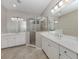 Spacious bathroom features dual vanities, a glass-enclosed shower, and modern fixtures at 11406 Belvedere Ter, Lakewood Ranch, FL 34211