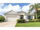 Charming home exterior with well-manicured landscaping, a two-car garage, and inviting curb appeal at 11406 Belvedere Ter, Lakewood Ranch, FL 34211