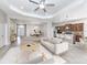 Open-concept living area flows into kitchen, featuring neutral decor, tiled floors, and comfortable seating at 11406 Belvedere Ter, Lakewood Ranch, FL 34211