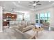 Bright, open living area with modern furnishings, tiled floors, and sliding glass doors to the outdoors at 11406 Belvedere Ter, Lakewood Ranch, FL 34211