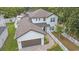Aerial view of a two-story home featuring a brown roof, a two-car garage, and a walkway lined by a white picket fence at 1807 Robinhood St, Sarasota, FL 34231