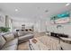Open floor plan showcasing a living room with a gray sectional sofa connected to the kitchen with barstool seating at 1807 Robinhood St, Sarasota, FL 34231