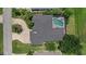 Aerial view of property showing roof, screened pool, circular driveway, and surrounding landscaping at 974 Rotonda Cir, Rotonda West, FL 33947