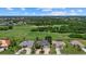 Beautiful aerial view of homes overlooking the manicured golf course, lush landscaping, and blue skies at 974 Rotonda Cir, Rotonda West, FL 33947