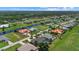 An aerial view showcases a neighborhood by the water and lush greenery, complete with charming homes at 974 Rotonda Cir, Rotonda West, FL 33947