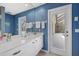 Bright bathroom featuring a modern vanity, ample counter space, and a door with access to outdoor space at 974 Rotonda Cir, Rotonda West, FL 33947