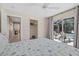 Bright bedroom with sliding glass doors leading to a screened-in pool area at 974 Rotonda Cir, Rotonda West, FL 33947