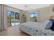 Bright bedroom with pool view from sliding glass doors at 974 Rotonda Cir, Rotonda West, FL 33947