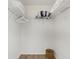 Walk-in closet featuring wire shelving with blankets, ample storage, and a wicker basket for organizing items at 974 Rotonda Cir, Rotonda West, FL 33947