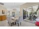 Formal dining room featuring a chandelier, seating for six, and sliding glass doors to the lanai at 974 Rotonda Cir, Rotonda West, FL 33947