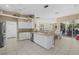 Bright, open kitchen with white cabinets, granite countertops, and views to the dining room at 974 Rotonda Cir, Rotonda West, FL 33947
