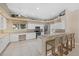 Spacious kitchen with custom white cabinets, granite counters, and a center island with seating at 974 Rotonda Cir, Rotonda West, FL 33947