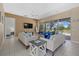 Inviting living room with views of the lanai and pool, tile flooring, and stylish furnishings at 974 Rotonda Cir, Rotonda West, FL 33947