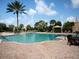 Large resort-style pool with lounge chairs and shade structures at 12610 Sorrento Way # 204, Bradenton, FL 34211