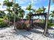 Serene outdoor space with a swing and lush landscaping at 12610 Sorrento Way # 204, Bradenton, FL 34211