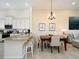 Kitchen island with seating and nearby dining table for six at 12610 Sorrento Way # 204, Bradenton, FL 34211