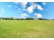 Landscaped golf course with lush green grass and homes in background at 811 Fairwaycove Ln # 107, Bradenton, FL 34212