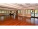 Large community room with hardwood floors and access to a pool view at 811 Fairwaycove Ln # 107, Bradenton, FL 34212