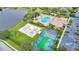 Aerial view of community amenities including pool, sports courts, and parking at 811 Fairwaycove Ln # 107, Bradenton, FL 34212