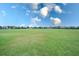 View of a lush green golf course with homes visible in the distance at 811 Fairwaycove Ln # 107, Bradenton, FL 34212